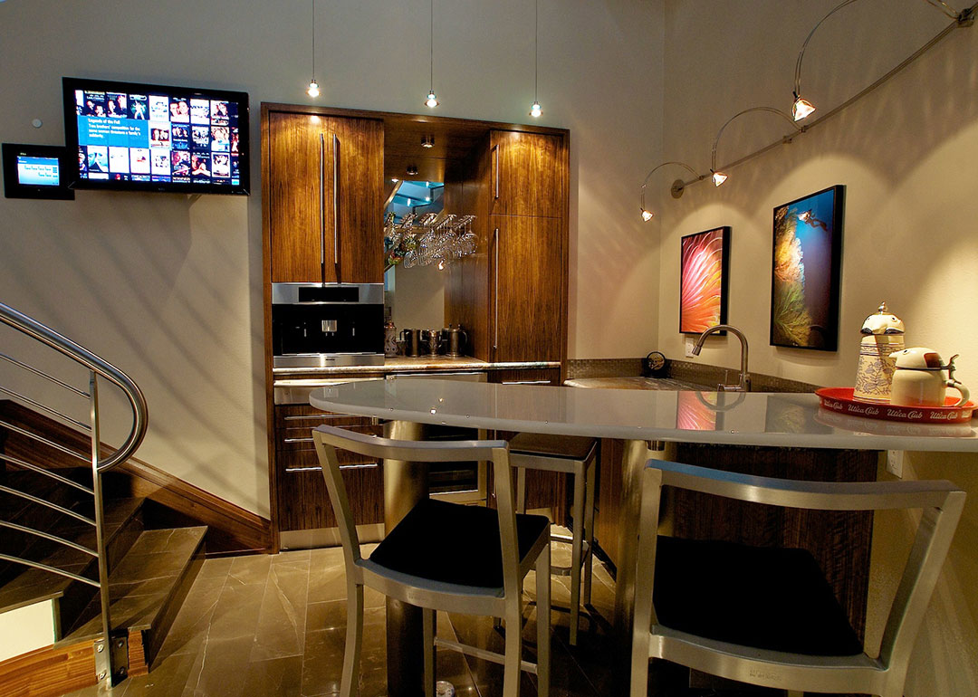 A modern bar design custom made to fit underneath an open spiral staircase. Rebecca Olsen Designs, Salem, OR